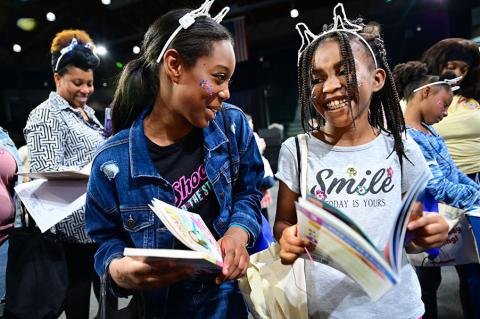 Attendees at 2025 Family Day at the Fest excitedly sharing book selections