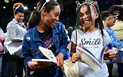 Attendees at 2025 Family Day at the Fest excitedly sharing book selections